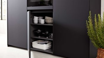 Einbauküche Interliving aus Holz in Schwarz Interliving Küche Serie 3035 mit AEG Einbaugeräten Schwarz & Quarzgrau – zweizeilig